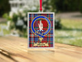 Close-up of the Miller family crest on a polished silver-frame metal ornament
