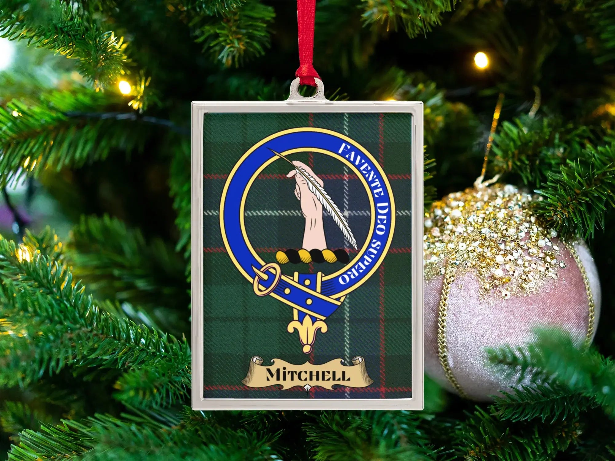 Mitchell clan crest Christmas ornament in a silver frame on a tartan background
