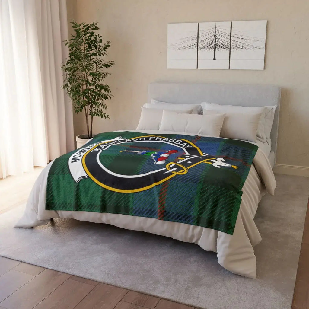 Morrison clan crest tartan throw blanket on bed — printed polyester with white reverse and hemmed edges