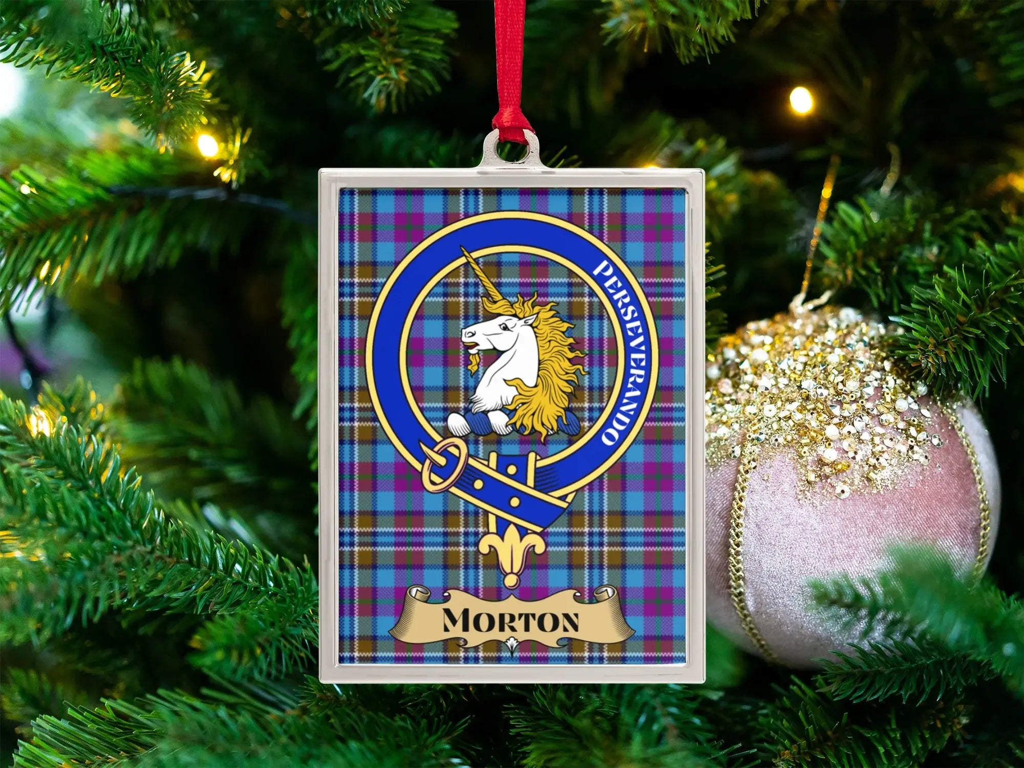 Morton clan crest Christmas ornament in a silver frame on a tartan background