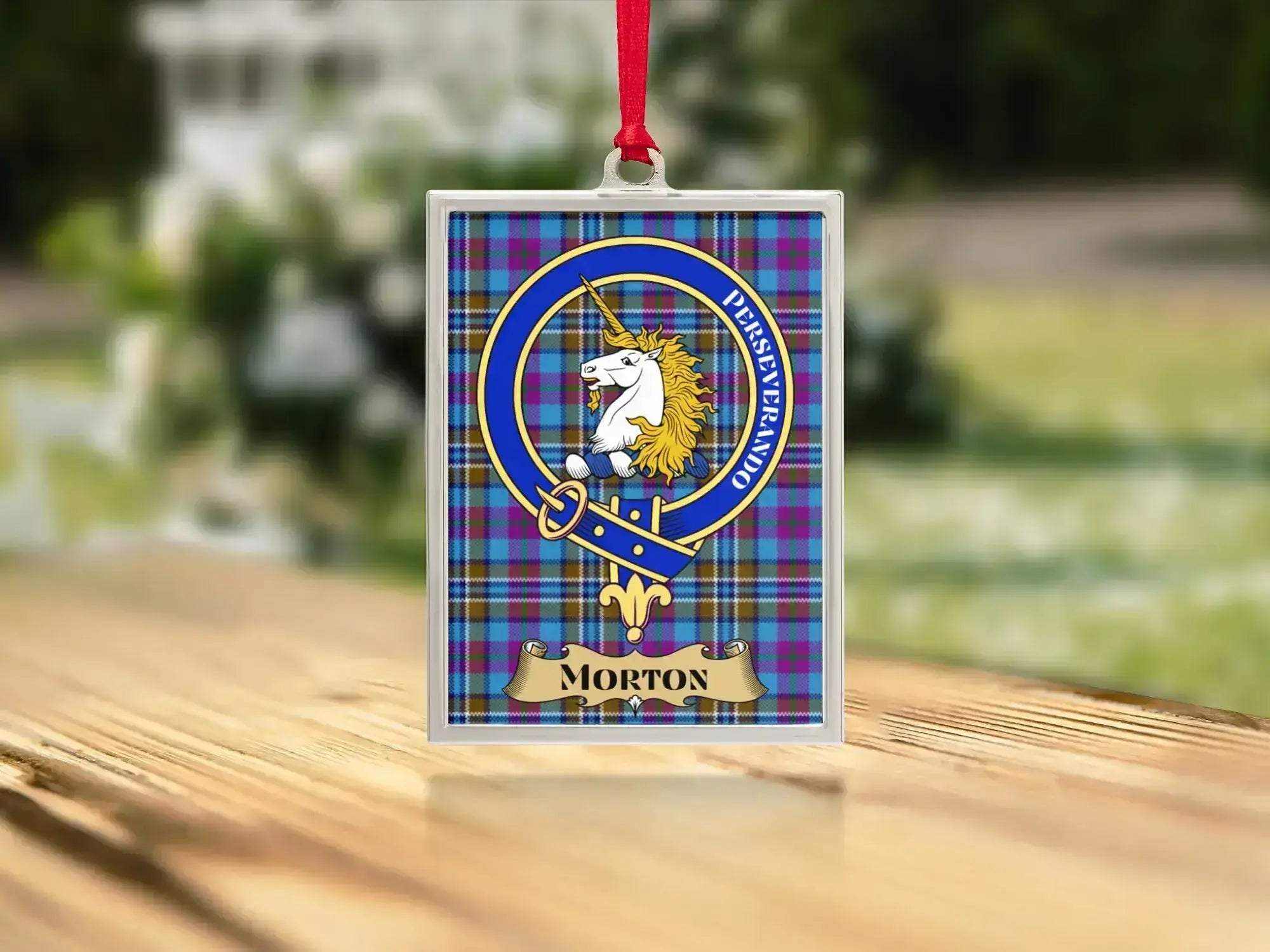Close-up of the Morton family crest on a polished silver-frame metal ornament