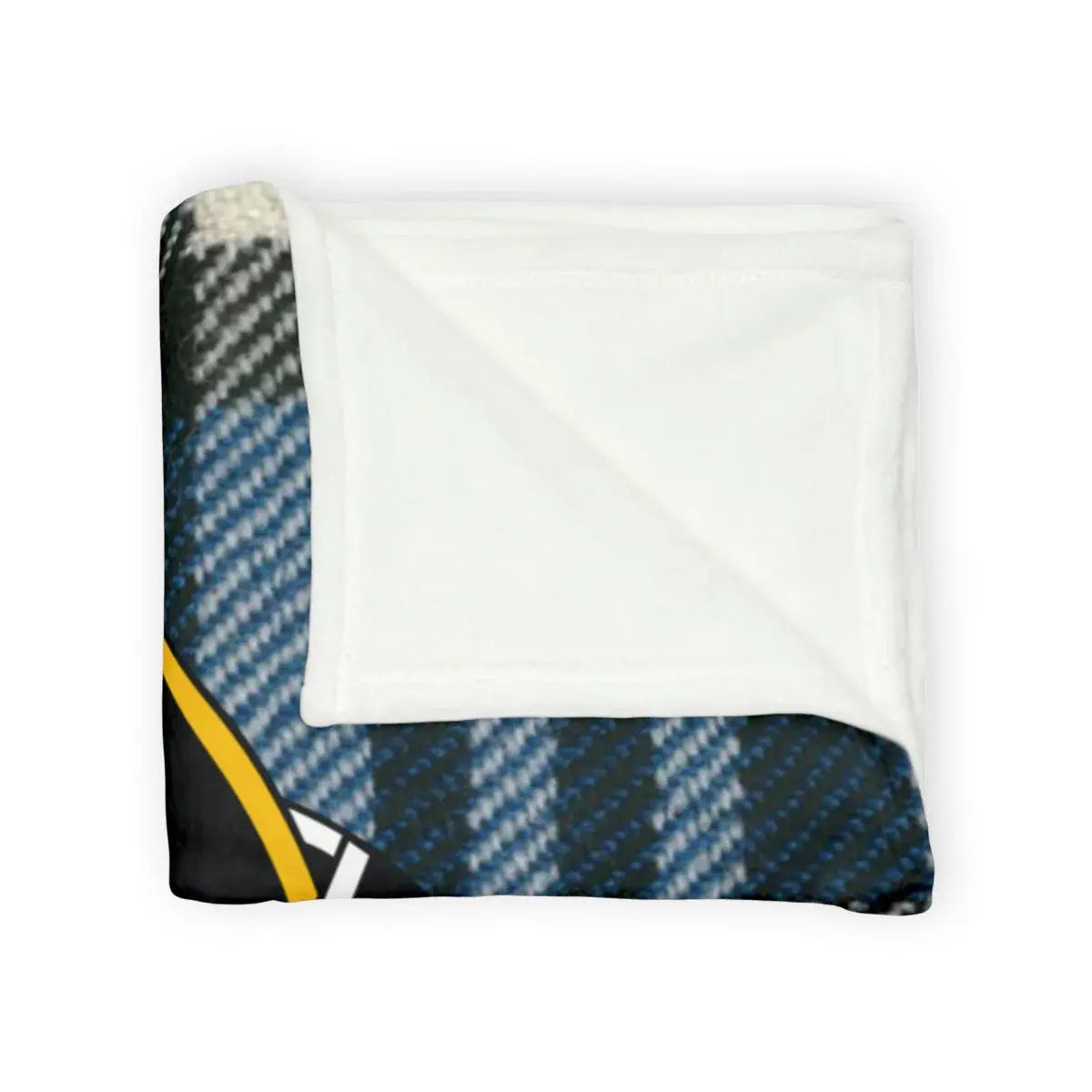 Napier tartan throw blanket on sofa — blue plaid with clan crest detail