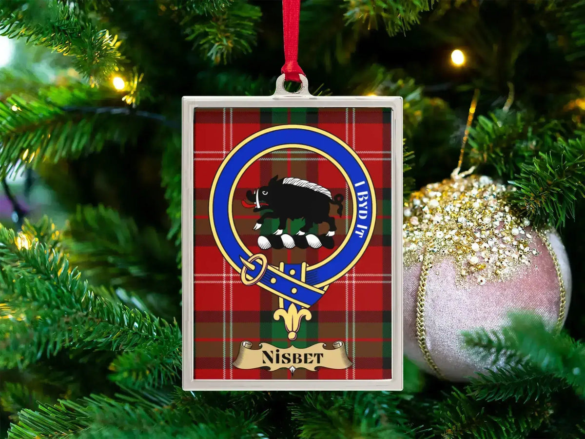 Nisbet clan crest Christmas ornament in a silver frame on a tartan background