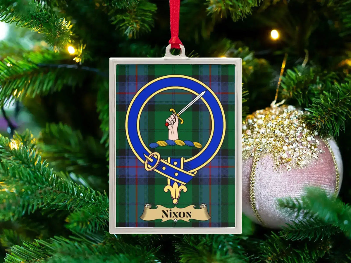 Nixon clan crest Christmas ornament in a silver frame on a tartan background