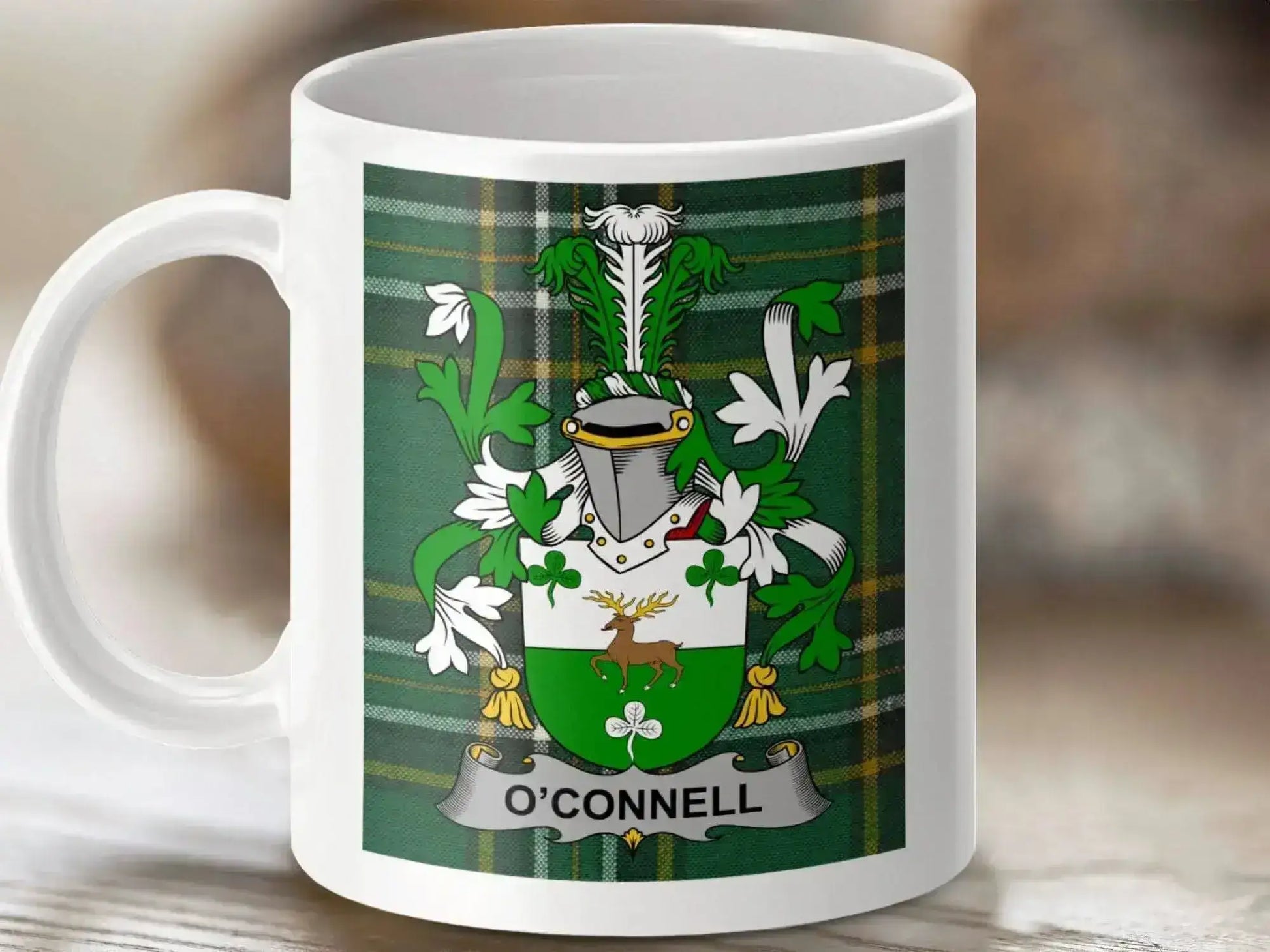 White ceramic mug with O'Connell family crest featuring green and white shield, stag, shamrocks, and helmet on tartan background