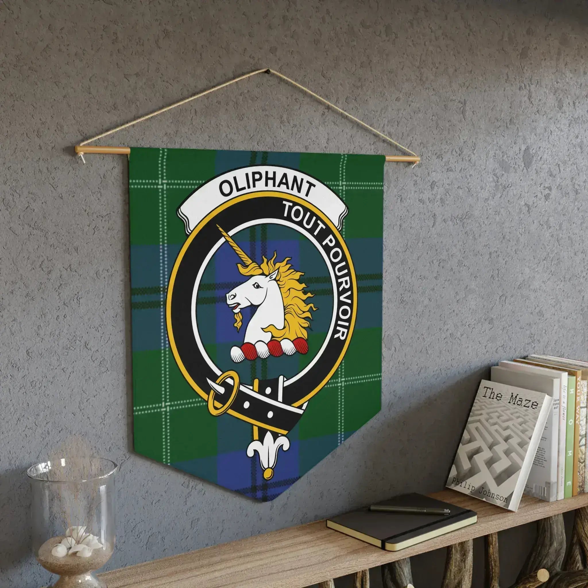 Oliphant unicorn crest pennant displayed on wall — tout pourvoir plaid design