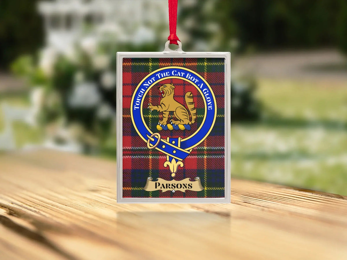 Close-up of the Parsons family crest on a polished silver-frame metal ornament