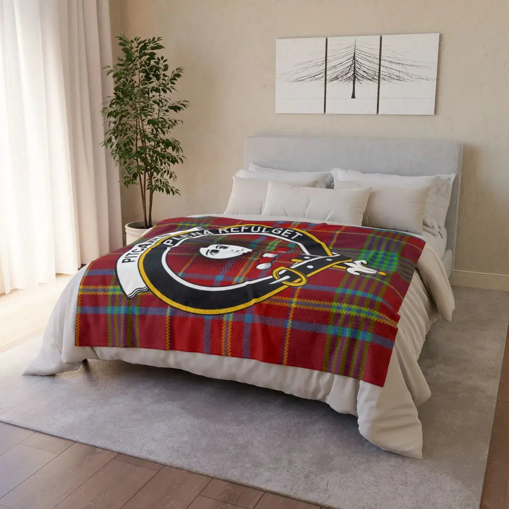 Pitcairn clan crest tartan throw draped on sofa — printed design, white reverse, hemmed edges