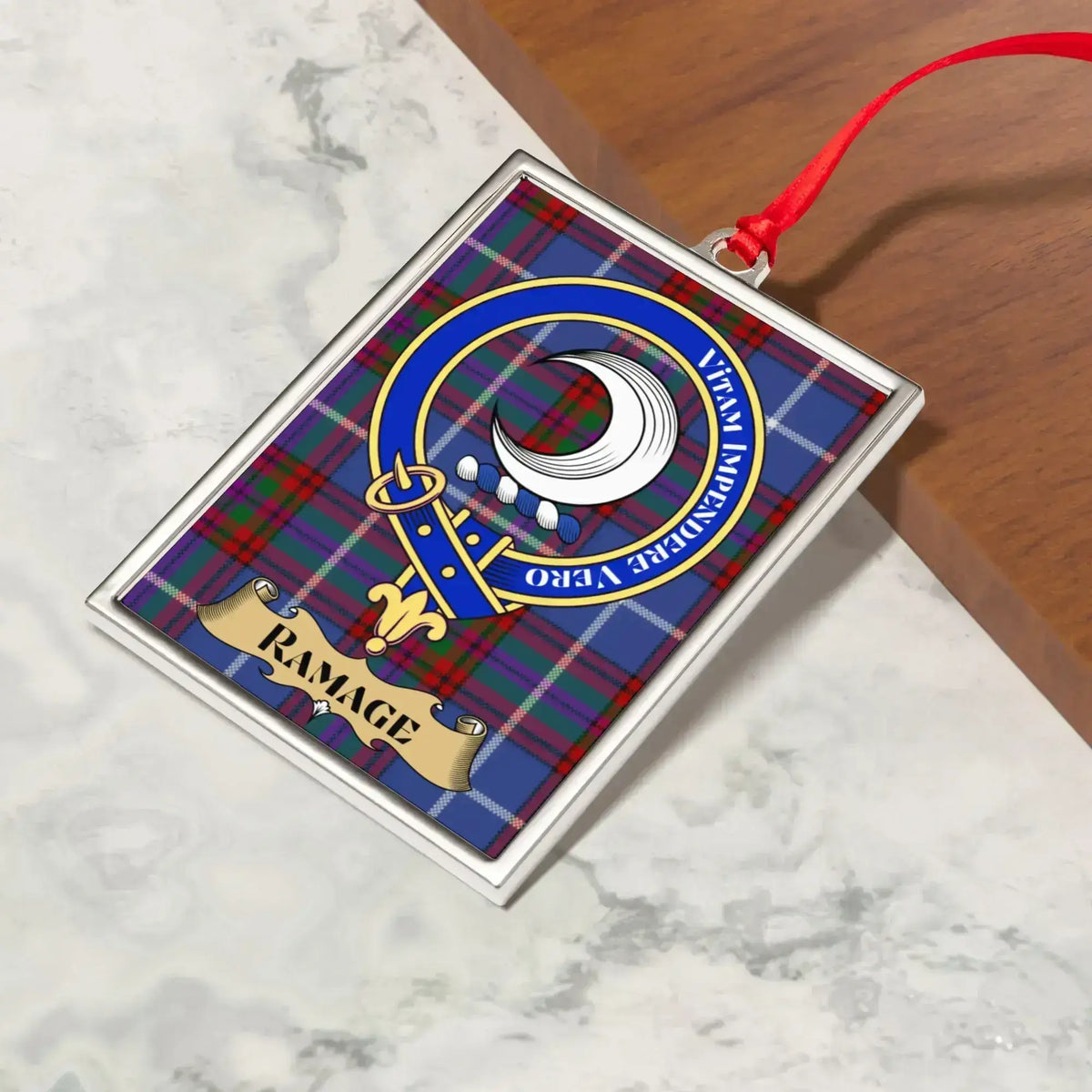 Ramage ornament hanging from a Christmas tree branch by its satin ribbon