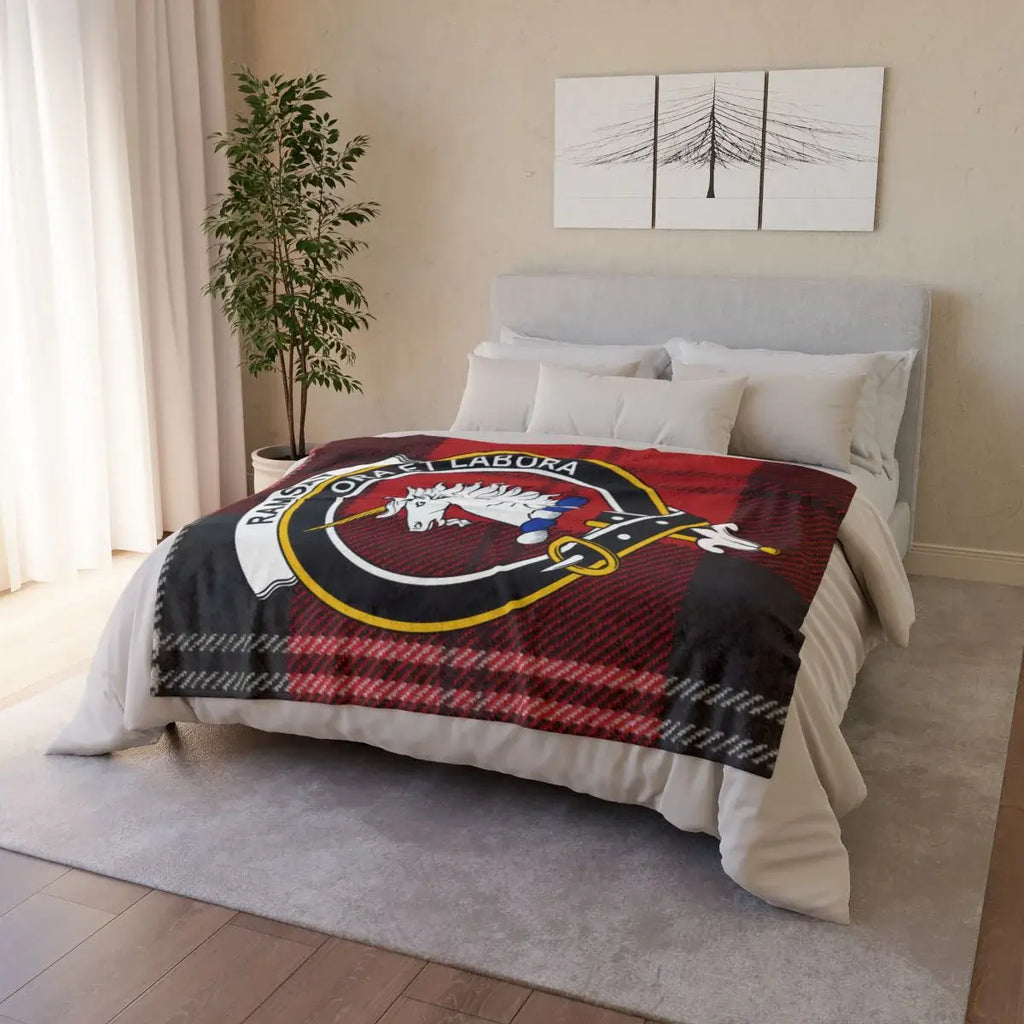 Clan Ramsay throw blanket folded — showing unicorn crest and red tartan print