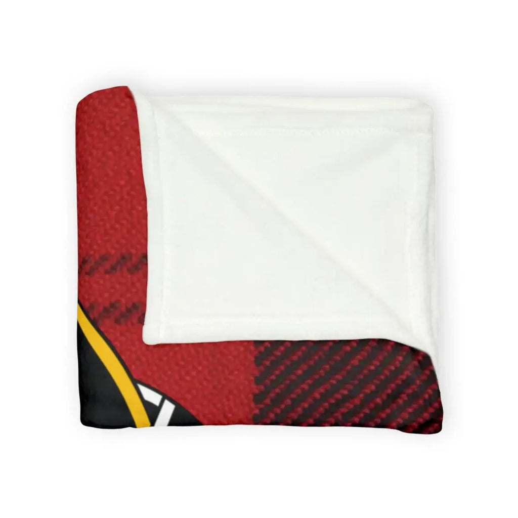 Ramsay tartan throw blanket on sofa — red and black plaid with clan crest
