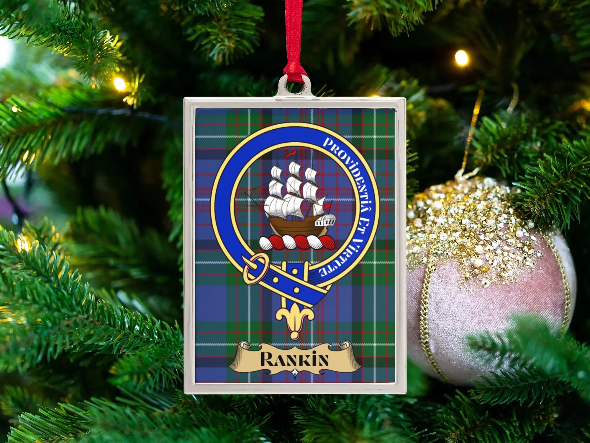 Rankin clan crest Christmas ornament in a silver frame on a tartan background