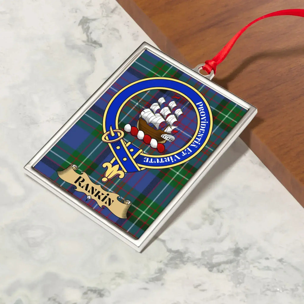 Rankin ornament hanging from a Christmas tree branch by its satin ribbon