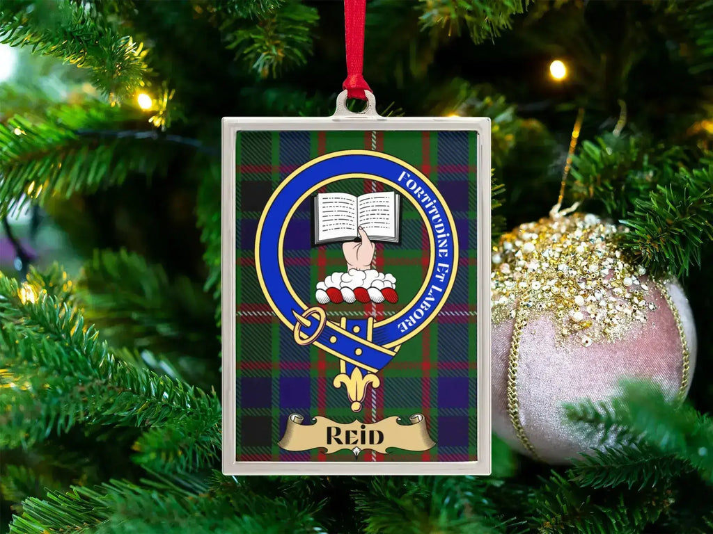 Reid clan crest Christmas ornament in a silver frame on a tartan background