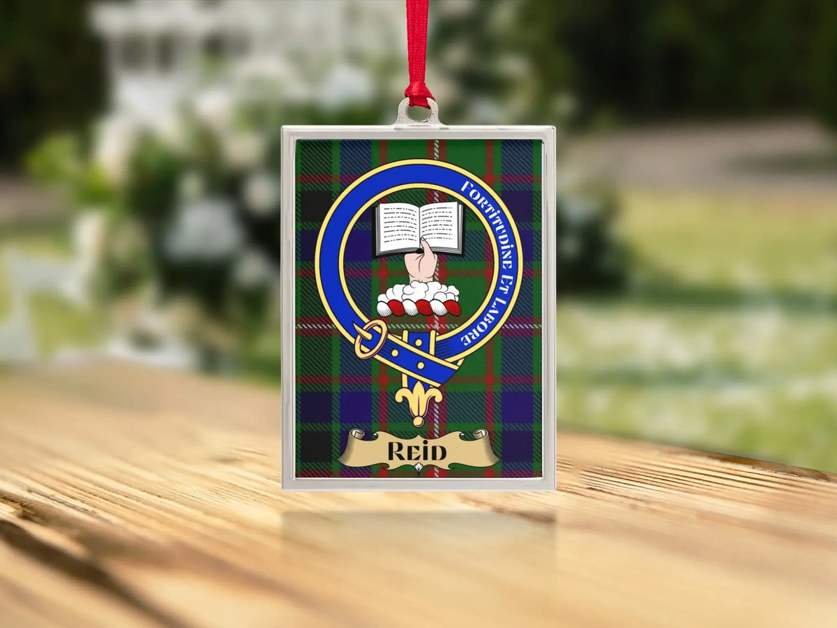 Close-up of the Reid family crest on a polished silver-frame metal ornament