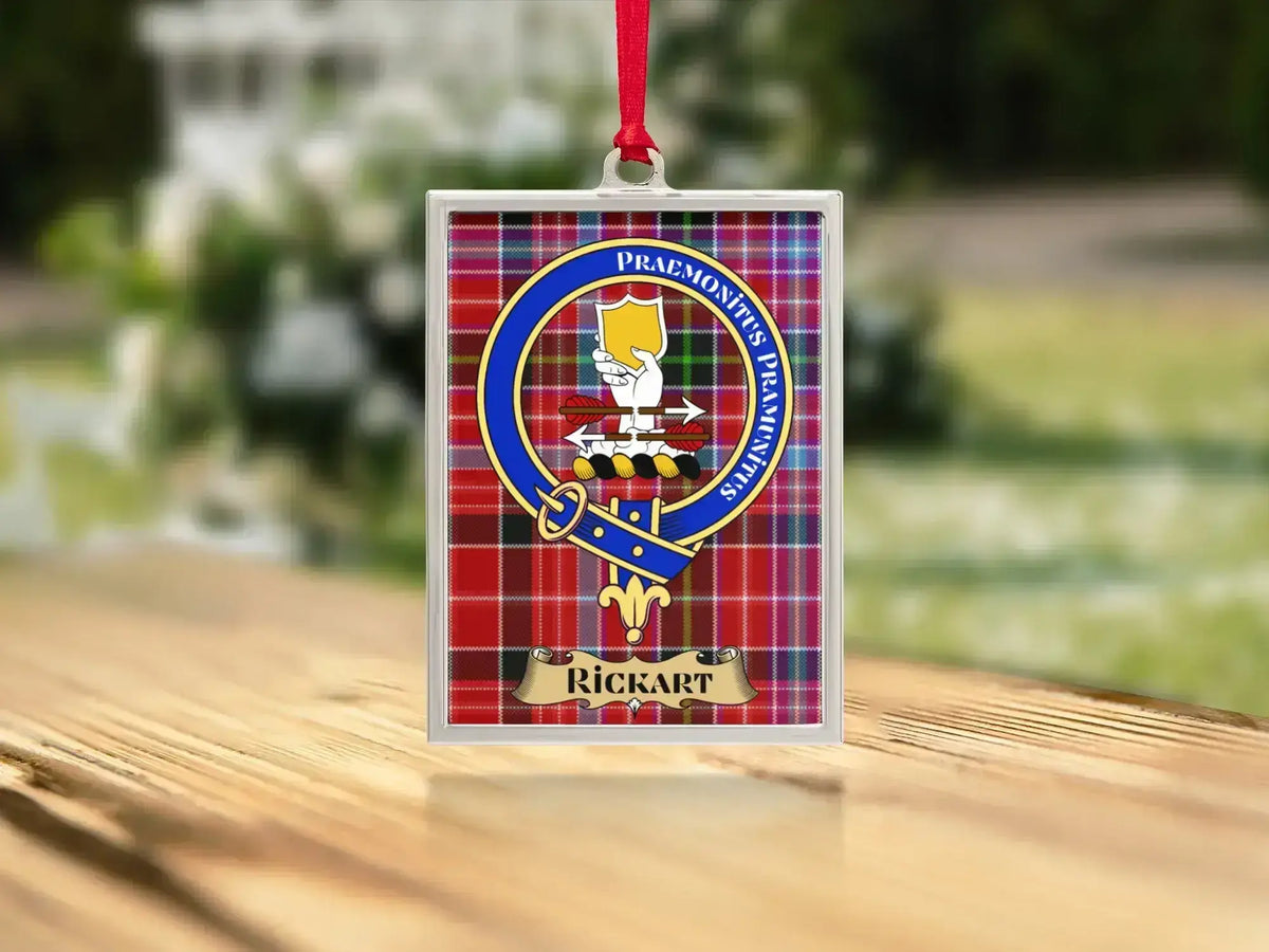 Close-up of the Rickart family crest on a polished silver-frame metal ornament