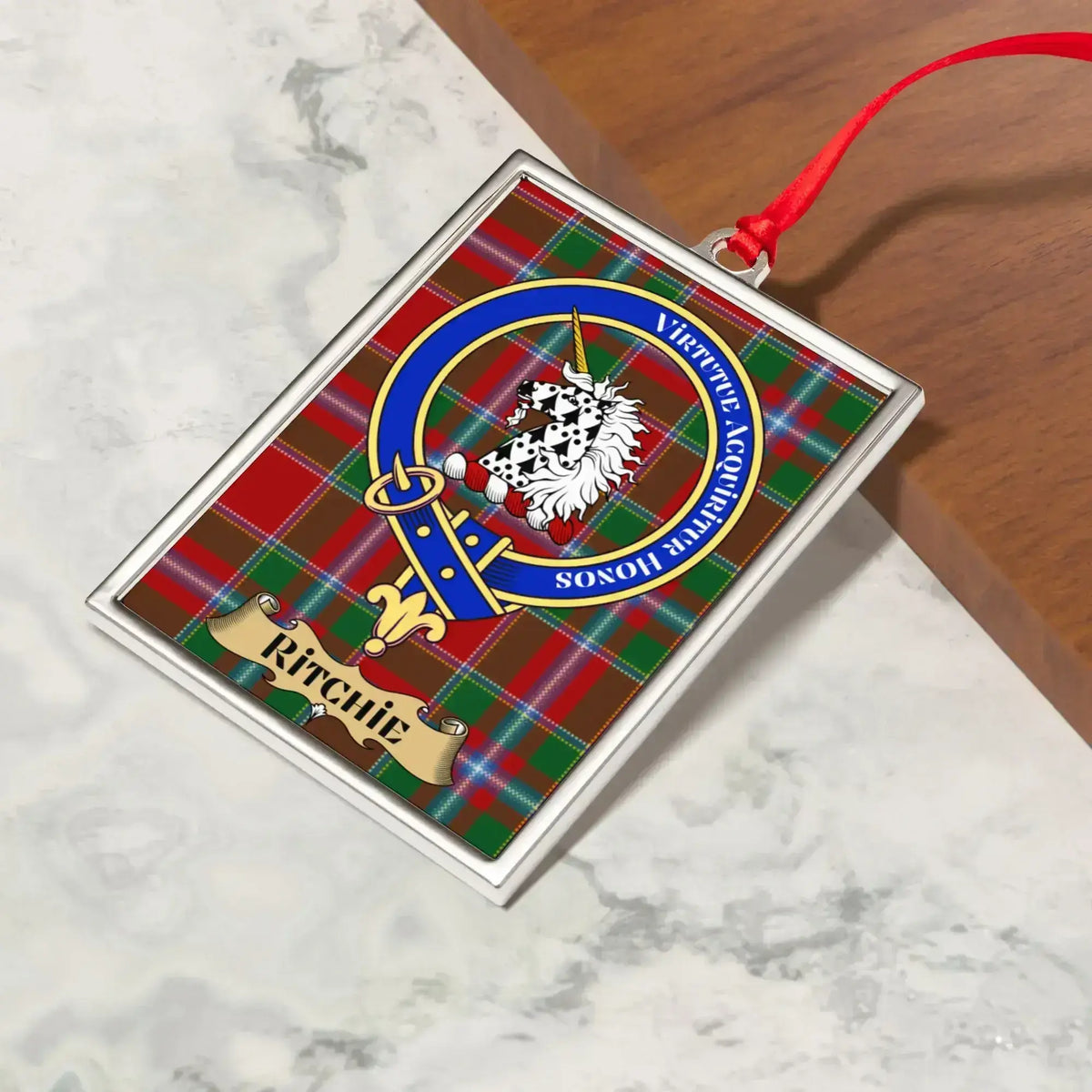 Ritchie ornament hanging from a Christmas tree branch by its satin ribbon