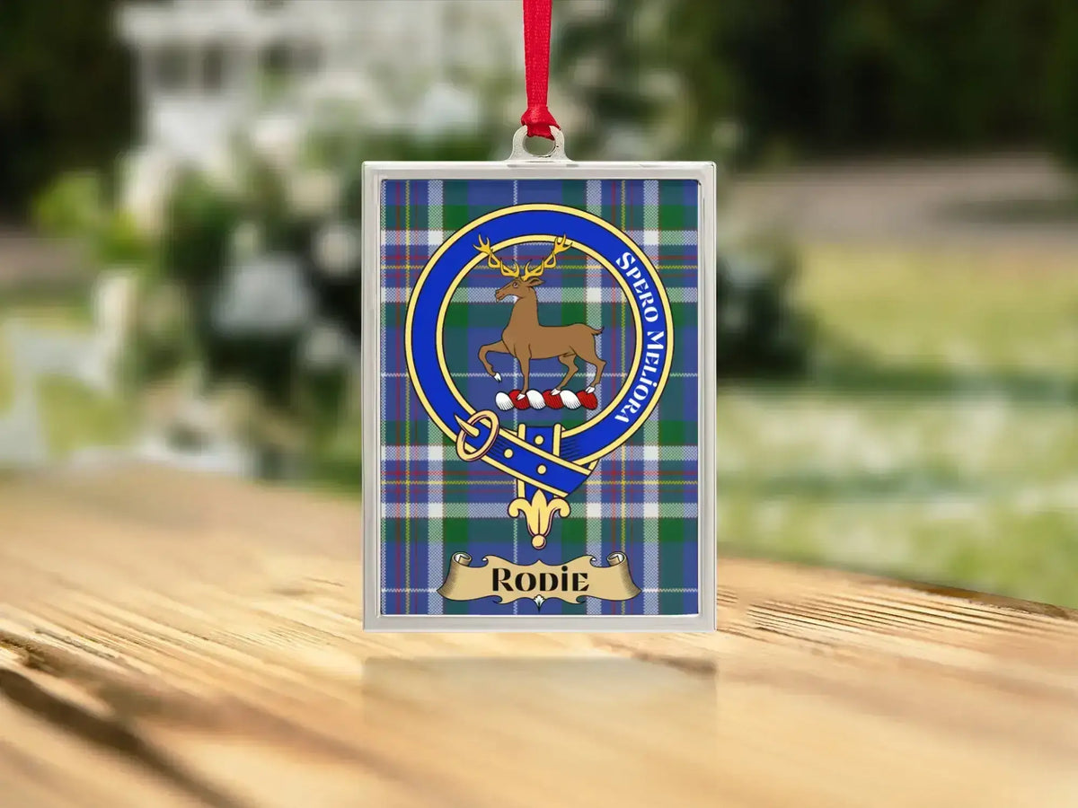 Close-up of the Rodie family crest on a polished silver-frame metal ornament