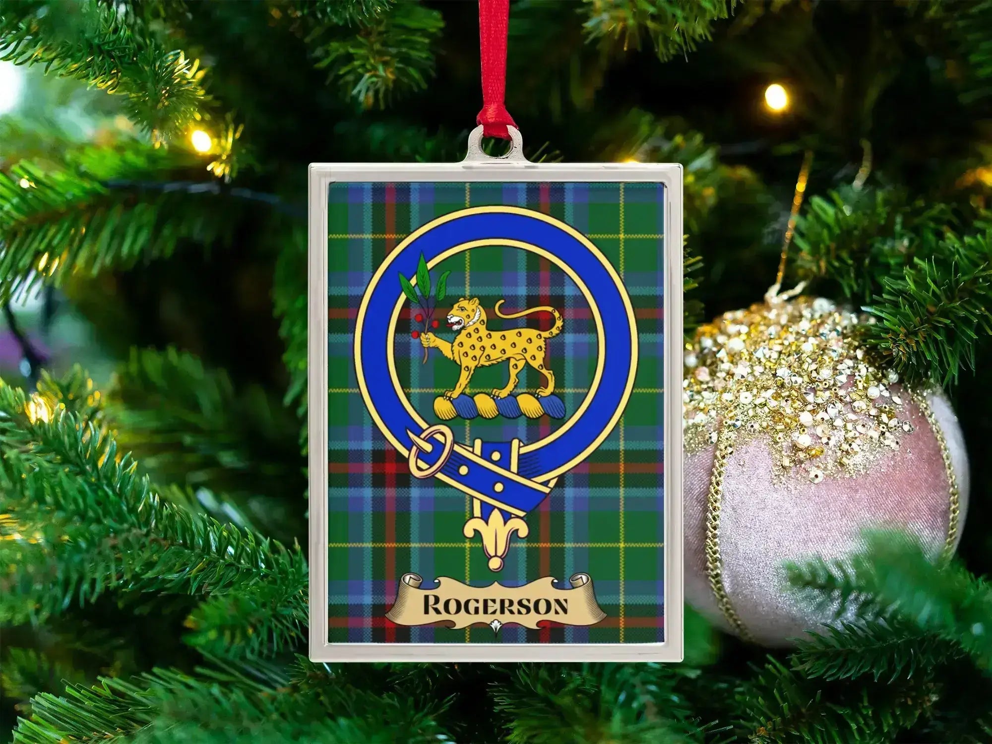 Rogerson clan crest Christmas ornament in a silver frame on a tartan background