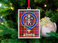 Rolland clan crest Christmas ornament in a silver frame on a tartan background