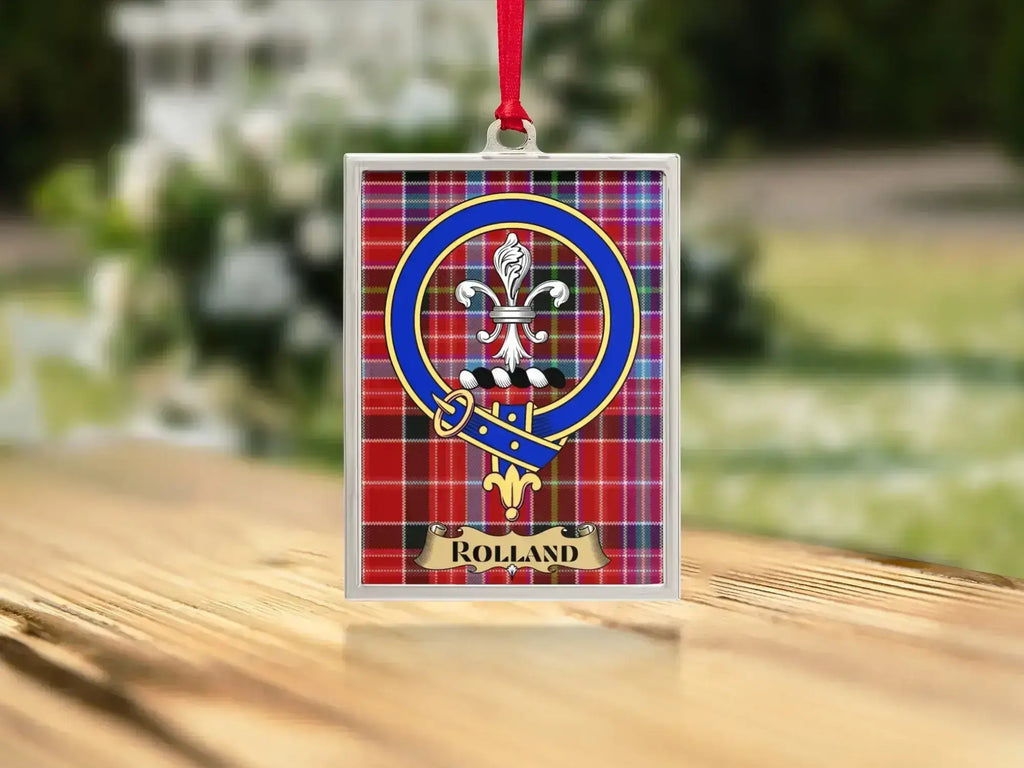 Close-up of the Rolland family crest on a polished silver-frame metal ornament