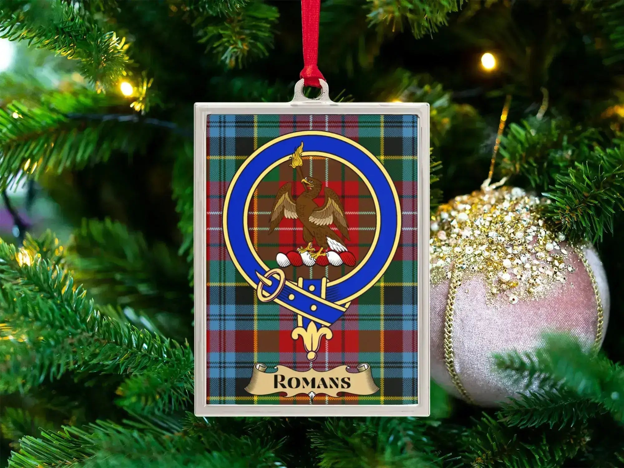 Romans clan crest Christmas ornament in a silver frame on a tartan background