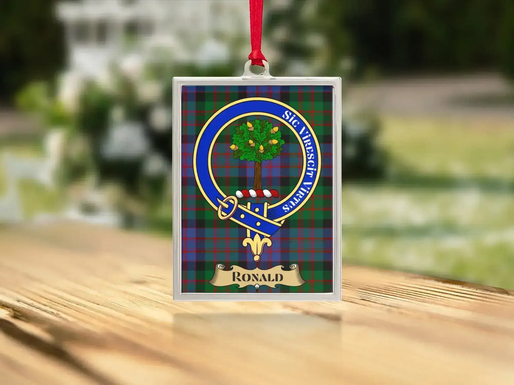 Close-up of the Ronald family crest on a polished silver-frame metal ornament