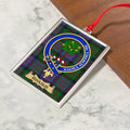 Ronald ornament hanging from a Christmas tree branch by its satin ribbon