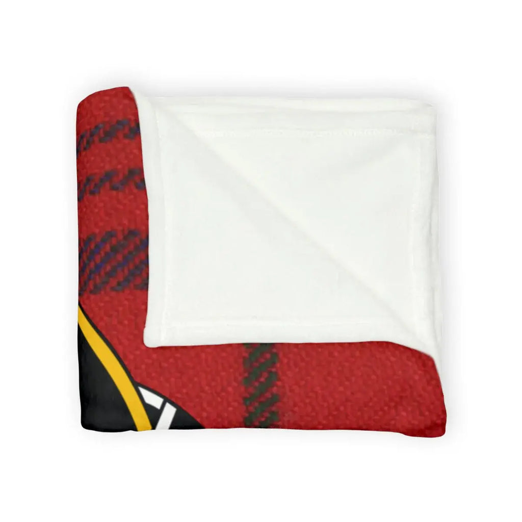 Rose tartan throw blanket on sofa — red plaid with constant and true crest