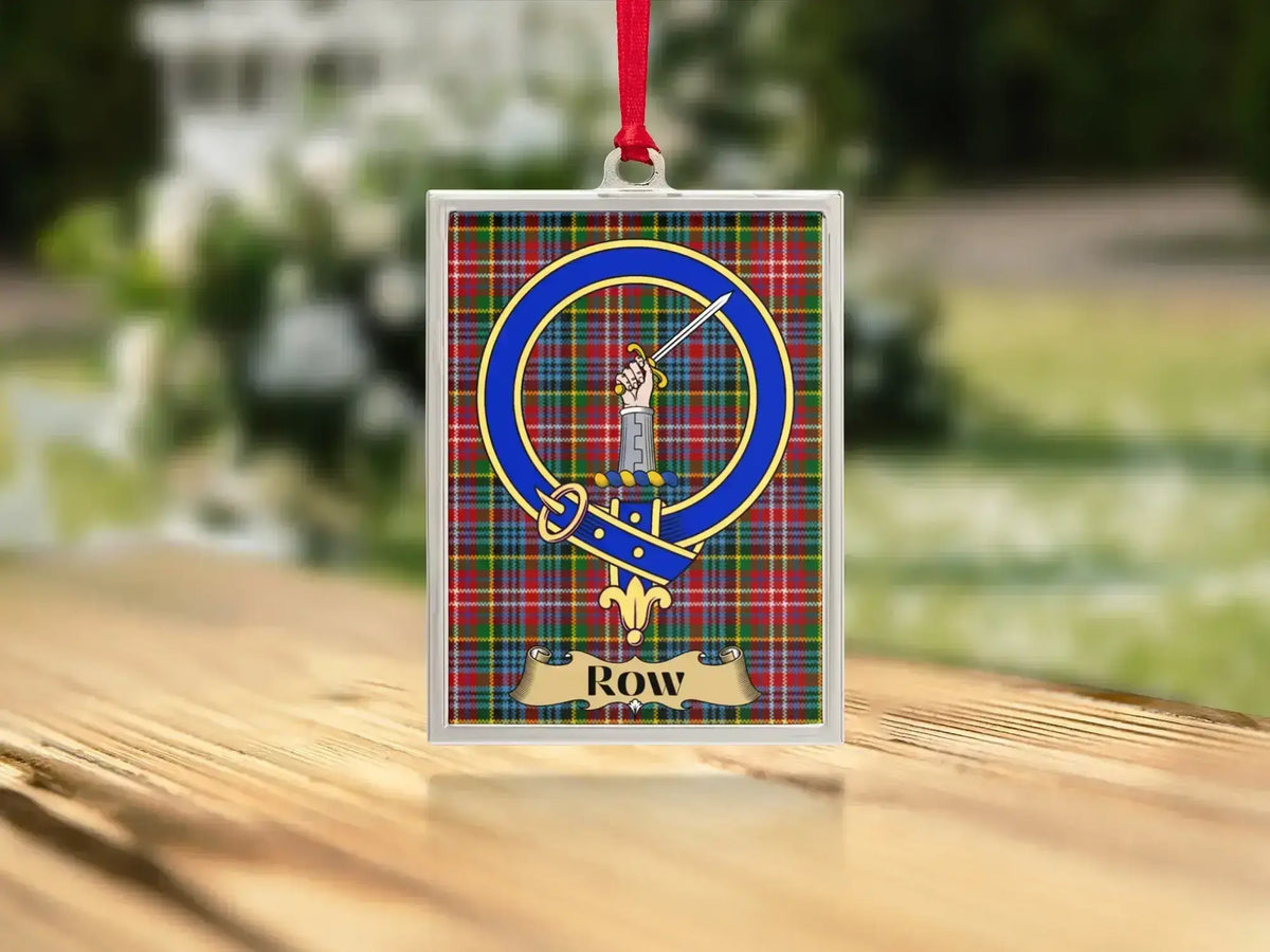 Close-up of the Row family crest on a polished silver-frame metal ornament