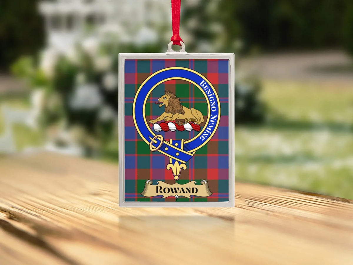 Close-up of the Rowand family crest on a polished silver-frame metal ornament