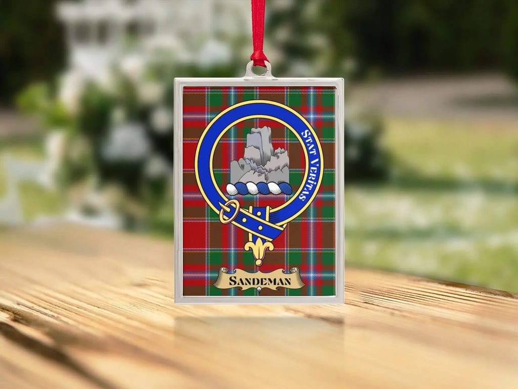 Close-up of the Sandeman family crest on a polished silver-frame metal ornament