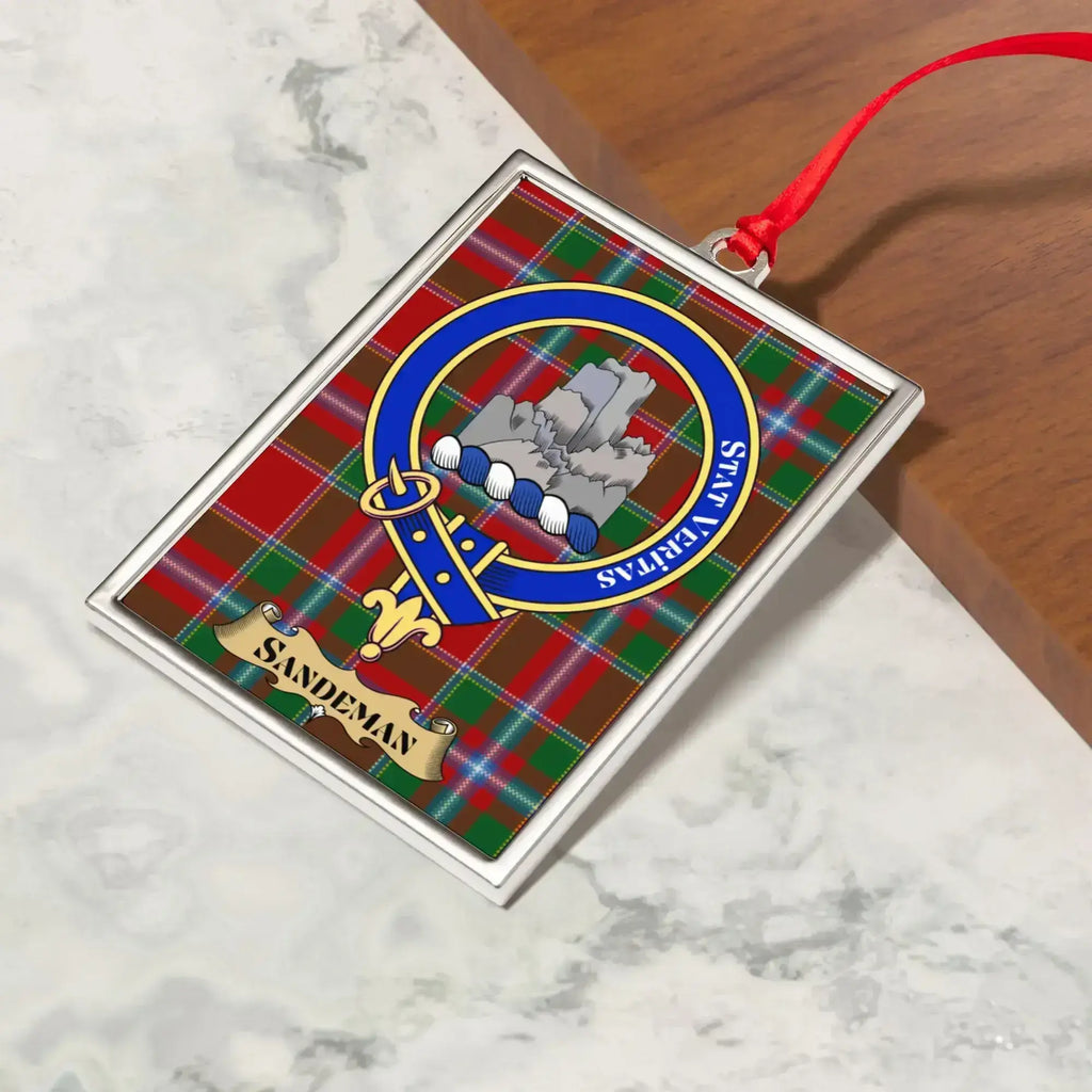 Sandeman ornament hanging from a Christmas tree branch by its satin ribbon
