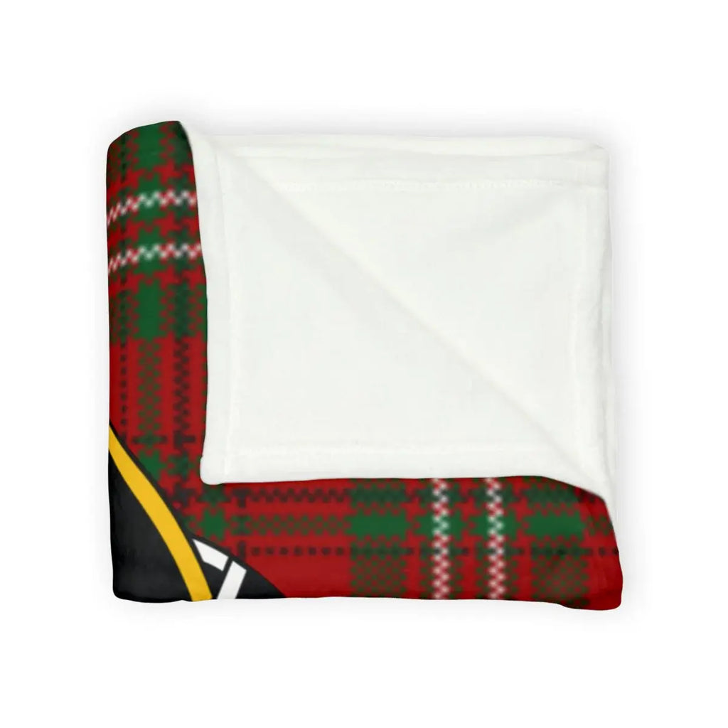 Scott tartan throw blanket on sofa — red and green plaid with deer crest