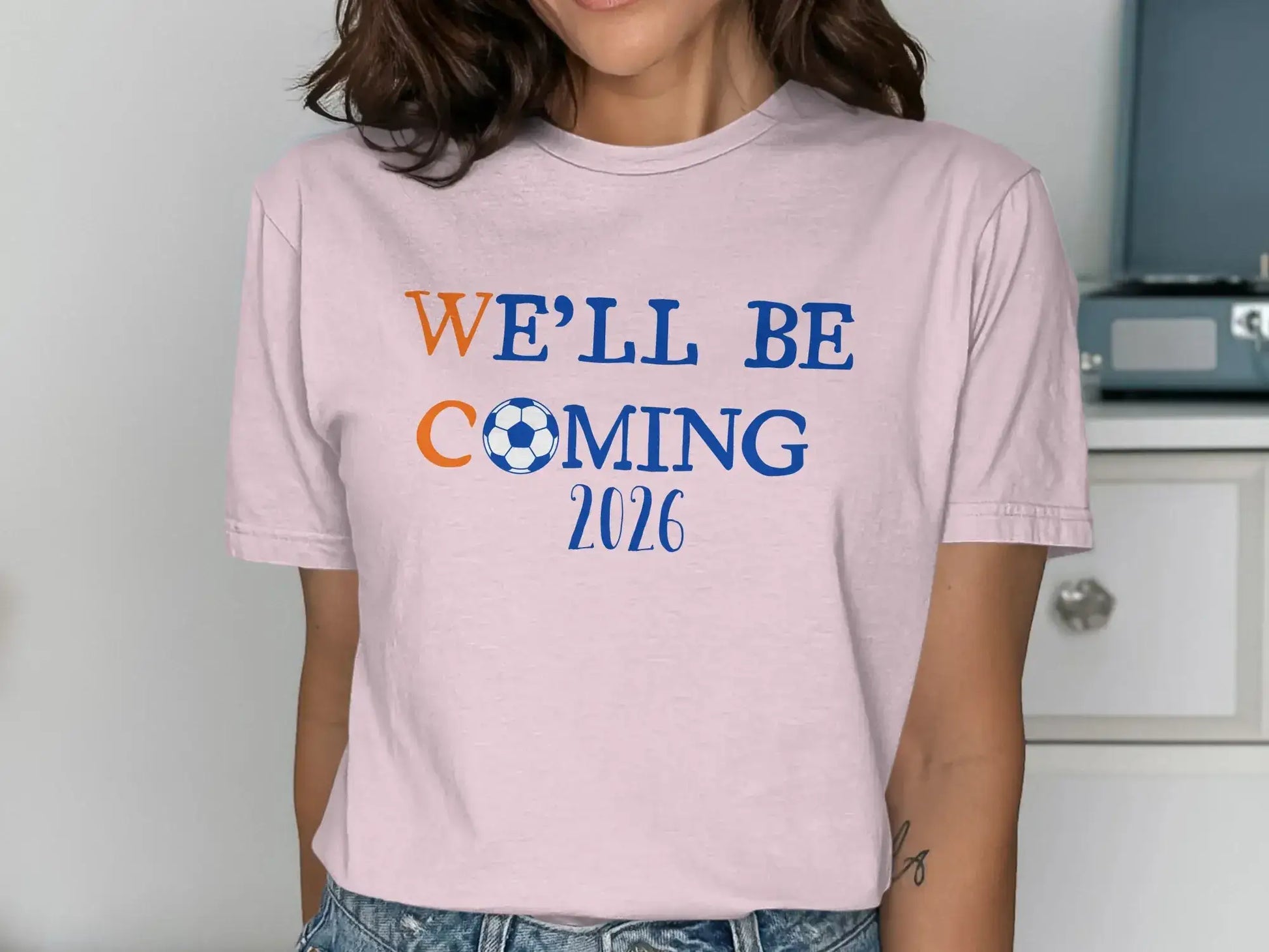 We'll Be Coming 2026 Soccer Fan Pink T-Shirt