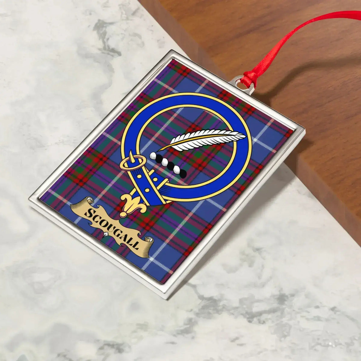 Scougall ornament hanging from a Christmas tree branch by its satin ribbon