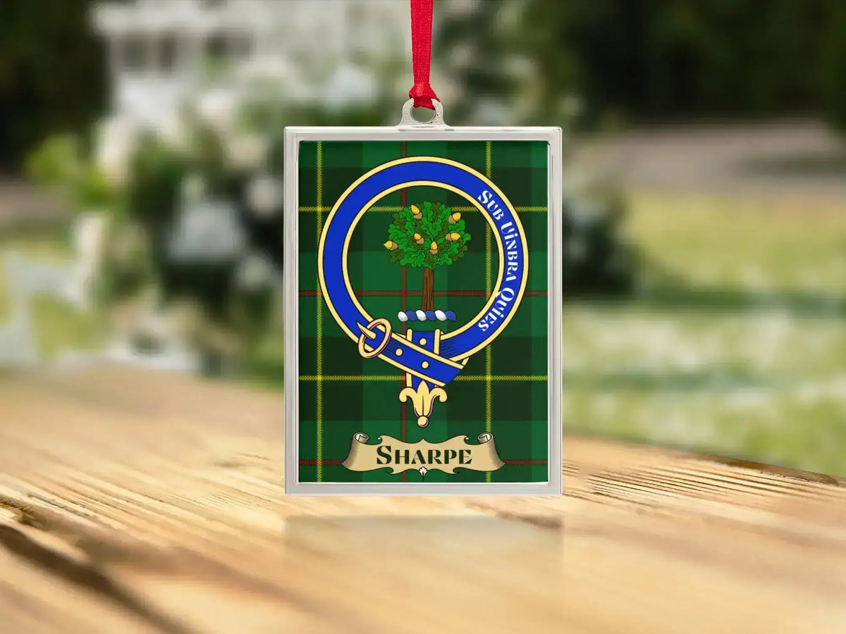 Close-up of the Sharpe family crest on a polished silver-frame metal ornament