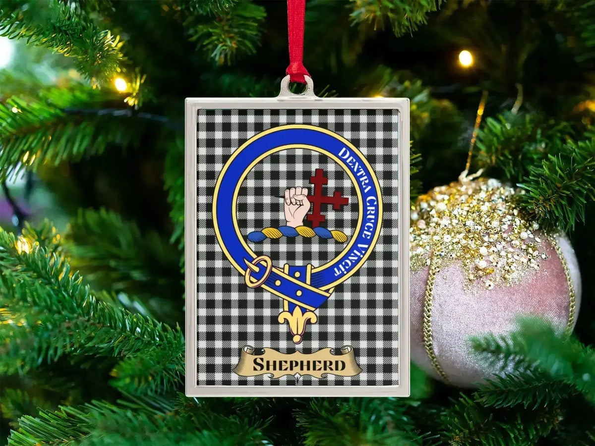 Shepherd clan crest Christmas ornament in a silver frame on a tartan background