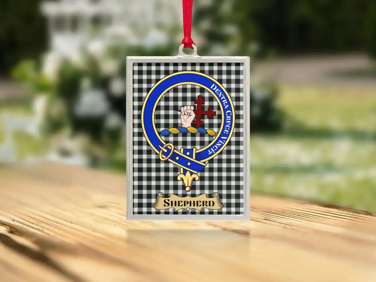 Close-up of the Shepherd family crest on a polished silver-frame metal ornament