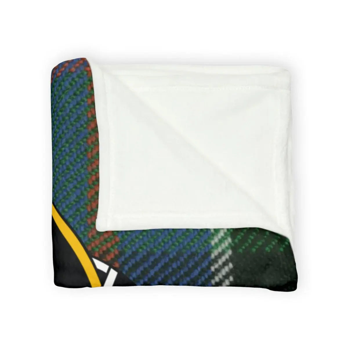 Sinclair tartan throw blanket on sofa — green and blue plaid with rooster crest