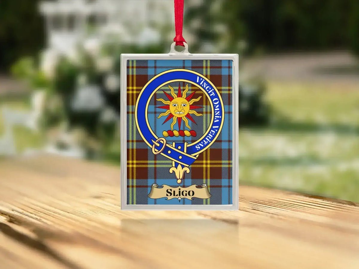 Close-up of the Sligo family crest on a polished silver-frame metal ornament