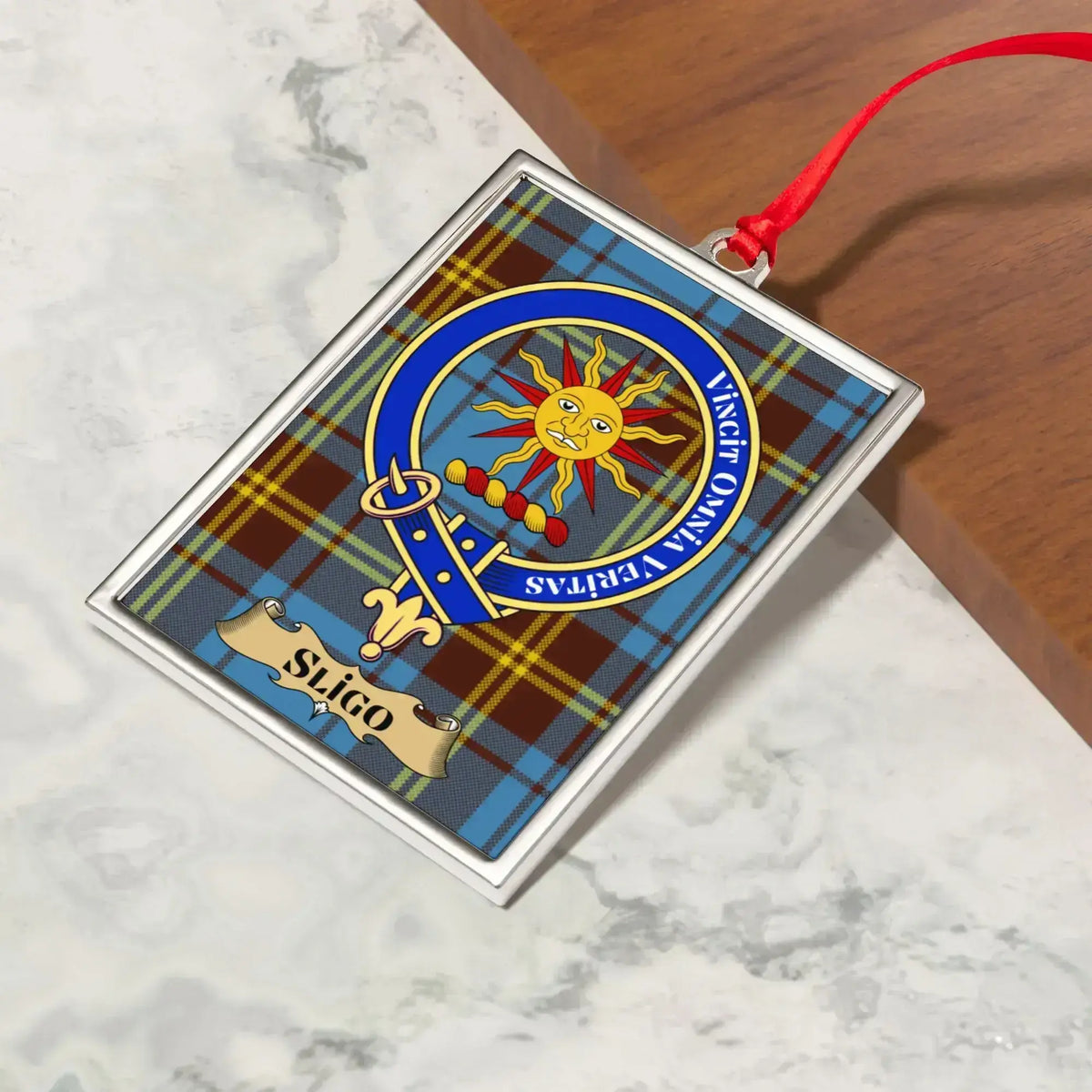 Sligo ornament hanging from a Christmas tree branch by its satin ribbon