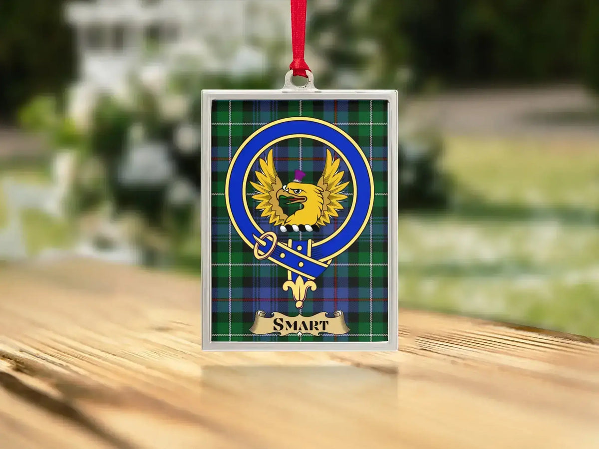 Close-up of the Smart family crest on a polished silver-frame metal ornament