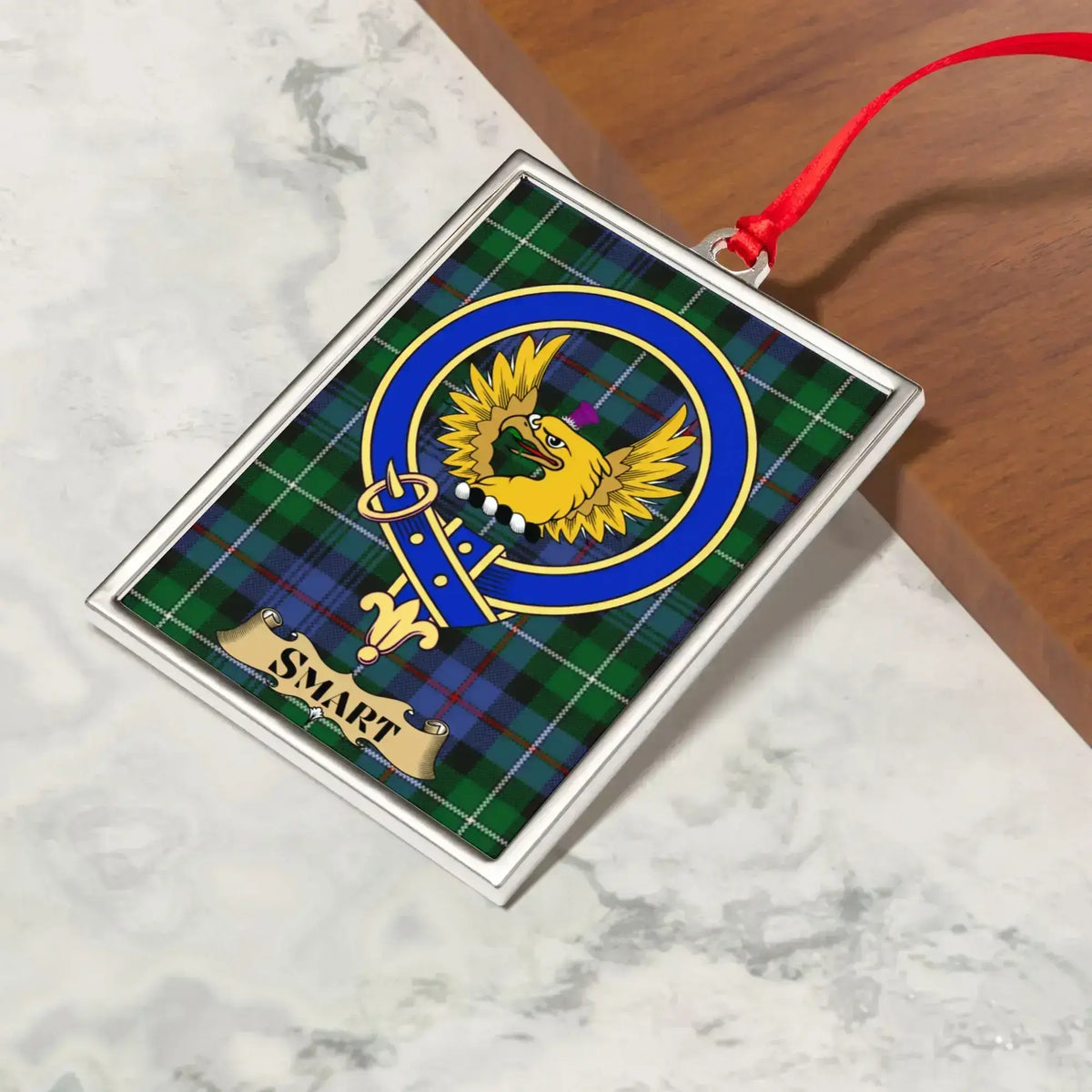 Smart ornament hanging from a Christmas tree branch by its satin ribbon