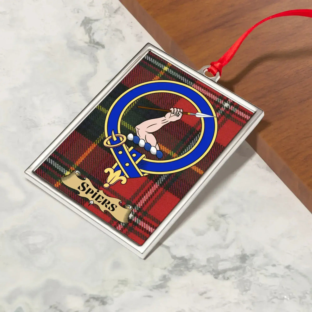 Spiers ornament hanging from a Christmas tree branch by its satin ribbon