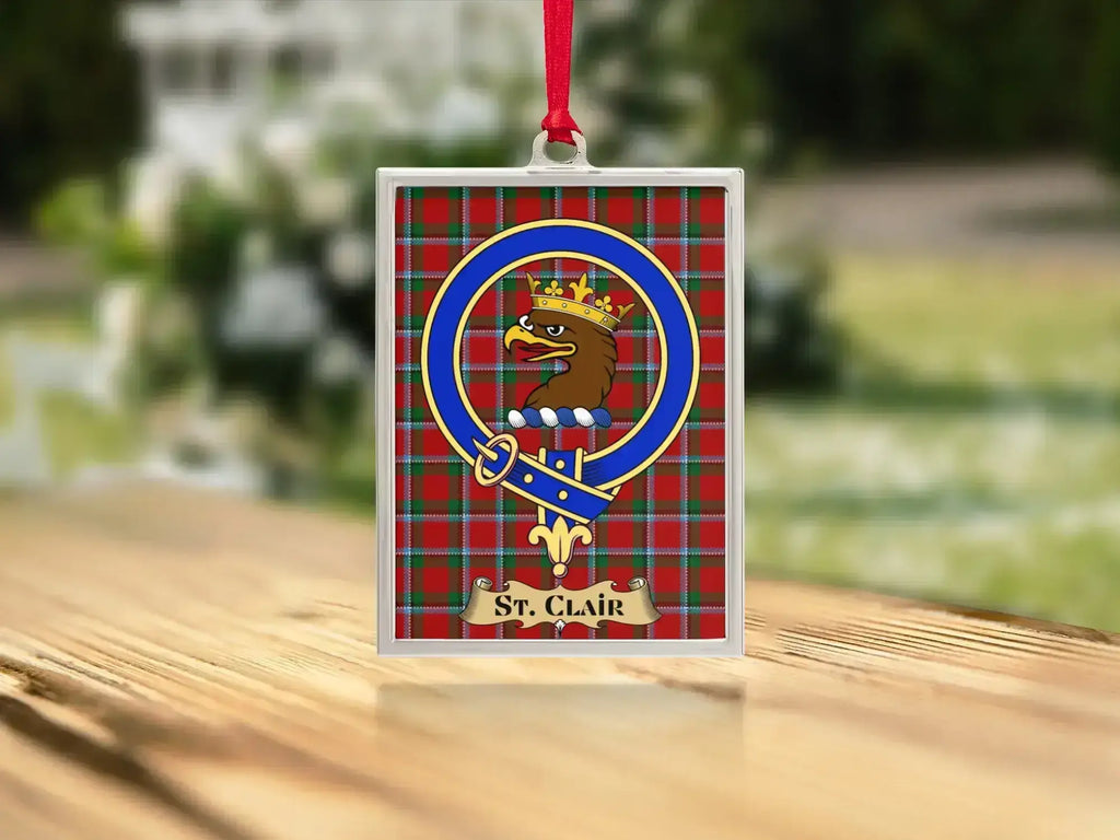 Close-up of the St Clair family crest on a polished silver-frame metal ornament