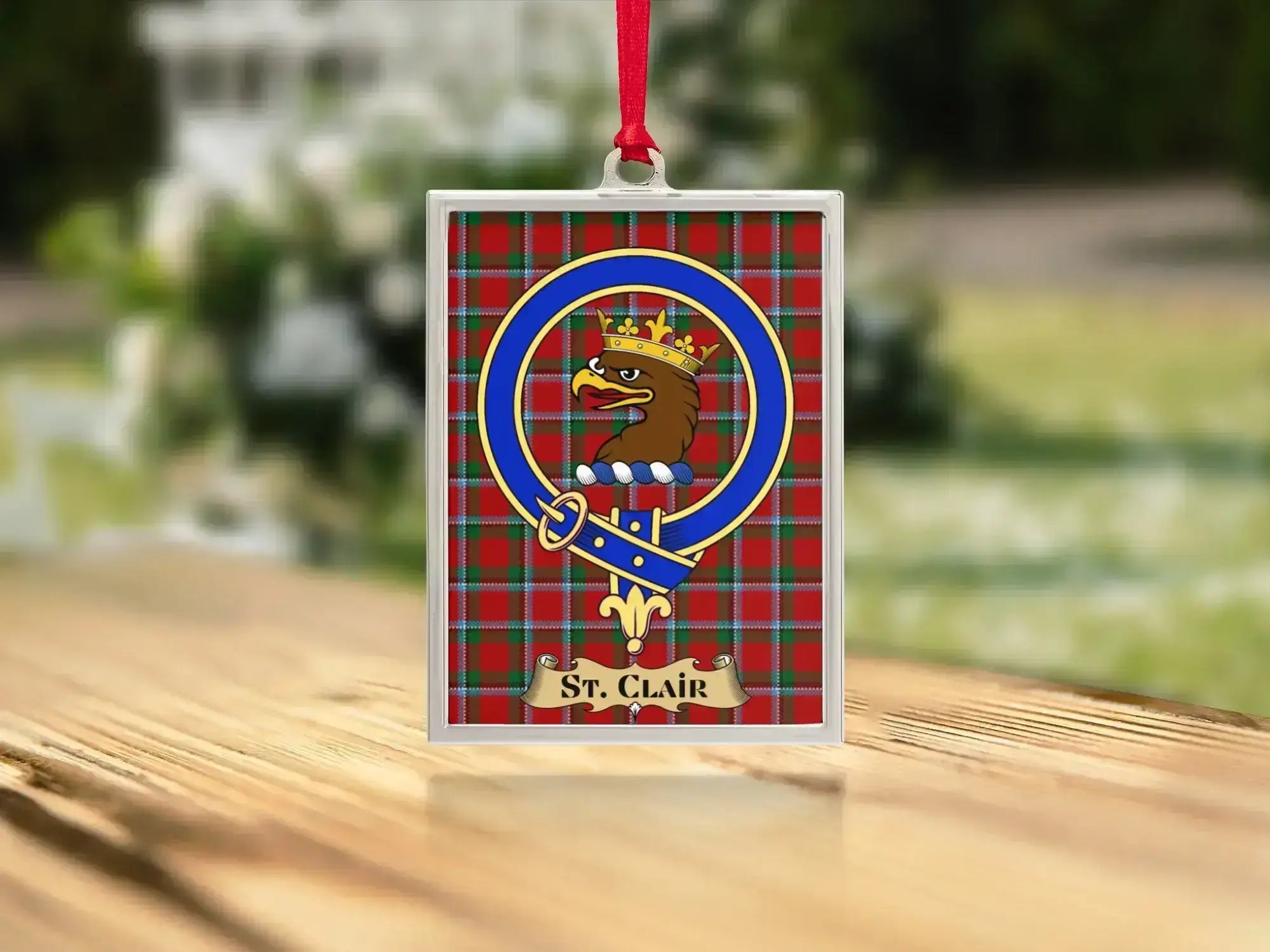 Close-up of the St Clair family crest on a polished silver-frame metal ornament