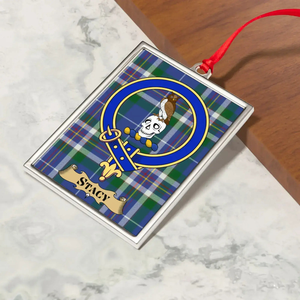 Stacy ornament hanging from a Christmas tree branch by its satin ribbon