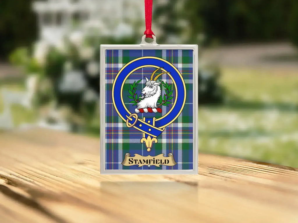 Close-up of the Stamfield family crest on a polished silver-frame metal ornament