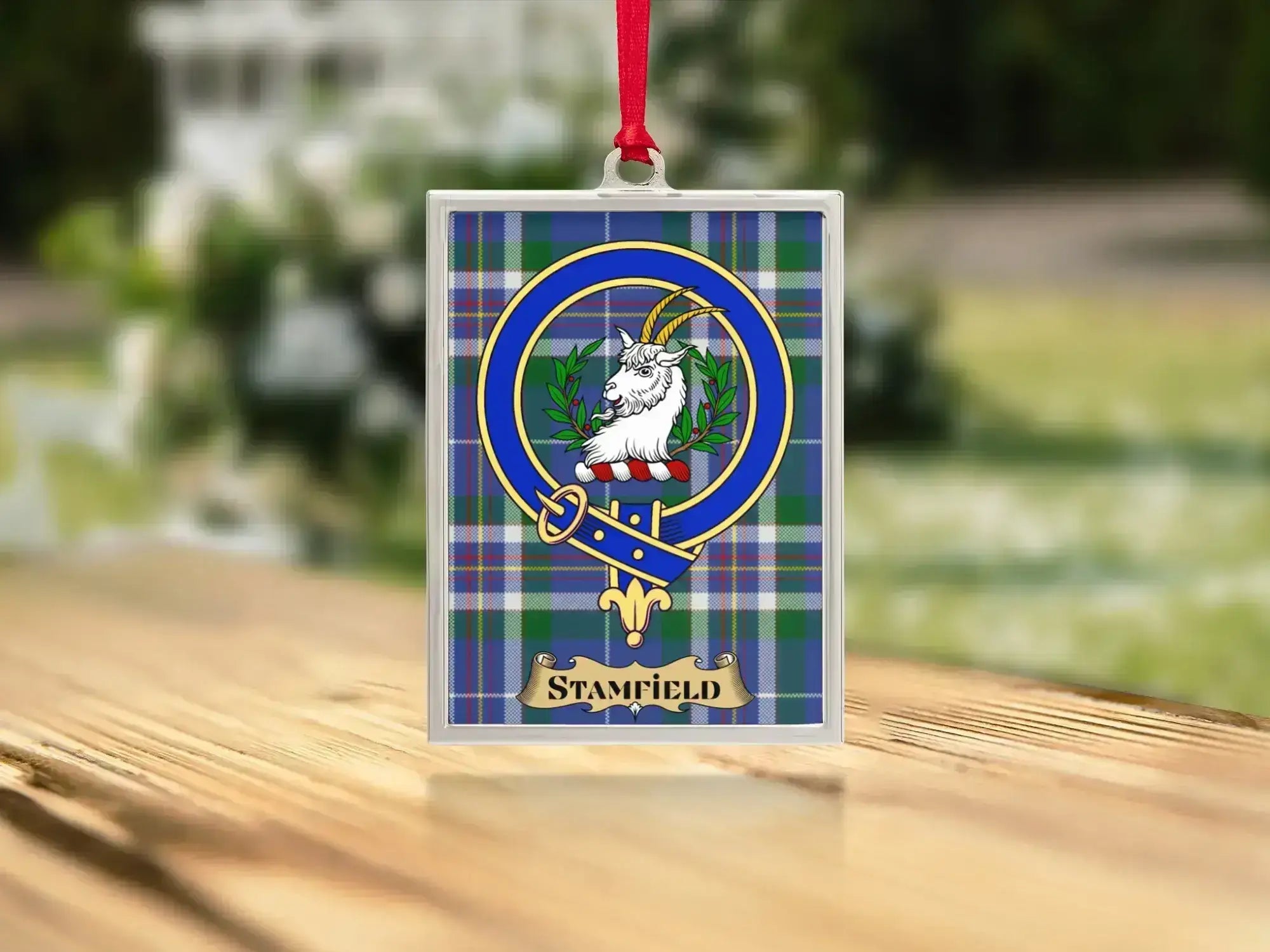 Close-up of the Stamfield family crest on a polished silver-frame metal ornament